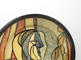 a plate with a painting of a woman on it