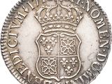 a silver coin with a crown on top of it