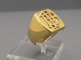 an image of a gold signet ring with a monogram on it