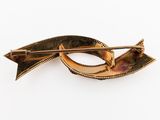 an image of a gold colored brooch with an arrow on it