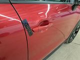 a close up of a car door handle with a sticker on it