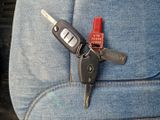 a car key that is sitting in the back seat of a car