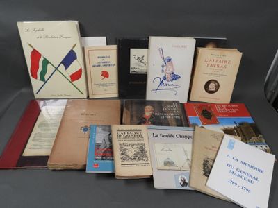 several books are stacked on top of each other on a table