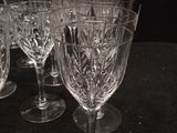 several empty wine glasses are lined up on a table