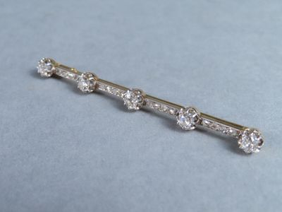 an image of a diamond bar broocher on a blue surface