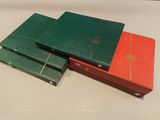 three green and red books stacked on top of each other