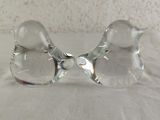 pair of clear glass bird figurines sitting on a white surface