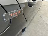 a close up of a car with a measuring tape on it ' s side