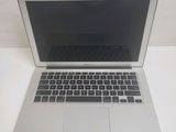 an apple macbook air laptop computer sitting on top of a white table