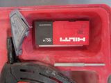 a red box with a tool in it on a table