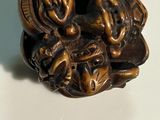 a close up of a small wooden object on a table