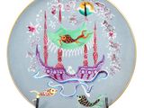 a decorative plate with a bird and fish on it