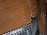 a cat that is sitting on the floor next to a cabinet