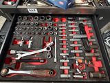 a drawer full of tools that is sitting on the floor