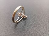 an image of a gold ring on a black surface