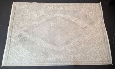 a white rug on a table with a black table cloth