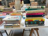 a lot of books on a table in a room