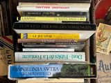 many books stacked on top of each other on the floor