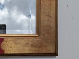 a mirror on the wall with a sky in the background