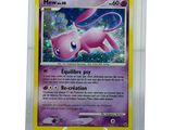 a close up of a pokemon card on a stand
