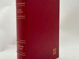 a red book sitting on top of a white surface