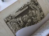 a close up of an old book with a picture of a man on it