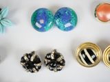 many different types of jewelry on a white surface