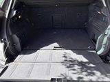 the back of a car with the trunk open and the cargo tray in the trunk