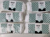 four bags of hally soap sitting on top of a table