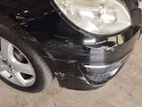 a picture of a car that has been dented and is in a garage