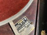 an old record player sitting on top of a wooden table
