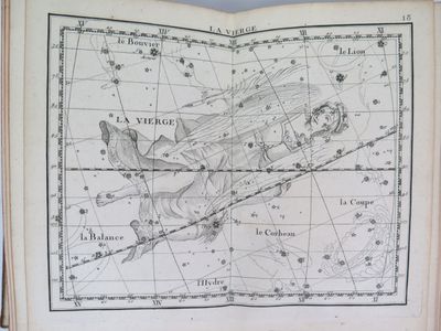 an old book with a map of the sky and constellations on it