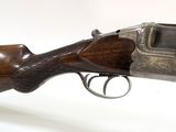 a close up of a rifle on a white surface with a white background