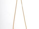 a gold necklace with a long chain on a white background