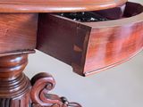 a wooden table with a drawer on top of it