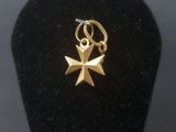 a small gold star charm on a black display case