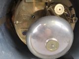 a clock that is sitting inside of a metal container