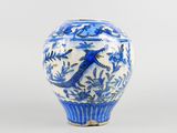 a blue and white vase with a bird on it