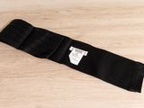 the belt is black and has a white label on it