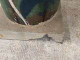 a green vase with blue and white designs on it