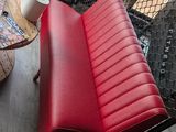 a red chair and a red ottoman in a living room