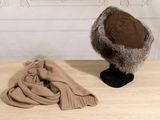 a hat and scarf sitting on a table next to a hat