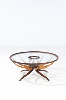 an image of a glass and wood coffee table with a circular glass top