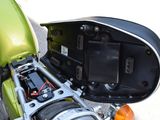 a close up of a green motorcycle with a black seat