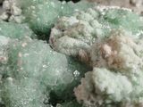 a close up of some green crystals in a bowl