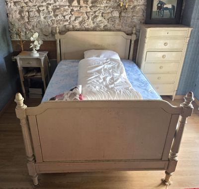 a bed that is in a room with a stone wall