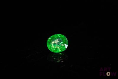 gros plan d'un diamant vert sur une surface noire