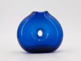 a blue vase with a hole in the middle of it