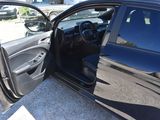 a black car with its door open on the side of the road