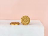 a gold coin sitting on top of a white block
